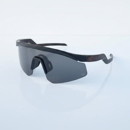 Black sunglasses packaging on a light surface
