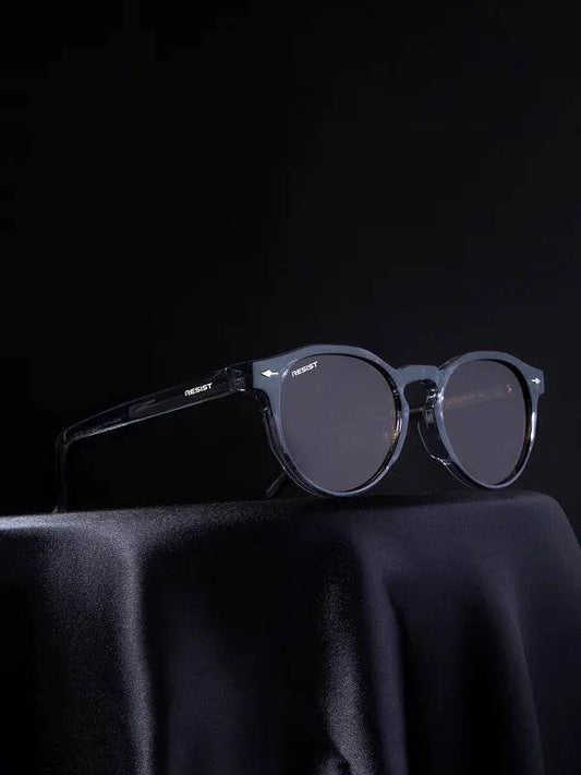 Sunglass Lover men's brown oval shades with translucent dark frame and smoke lenses on black drape