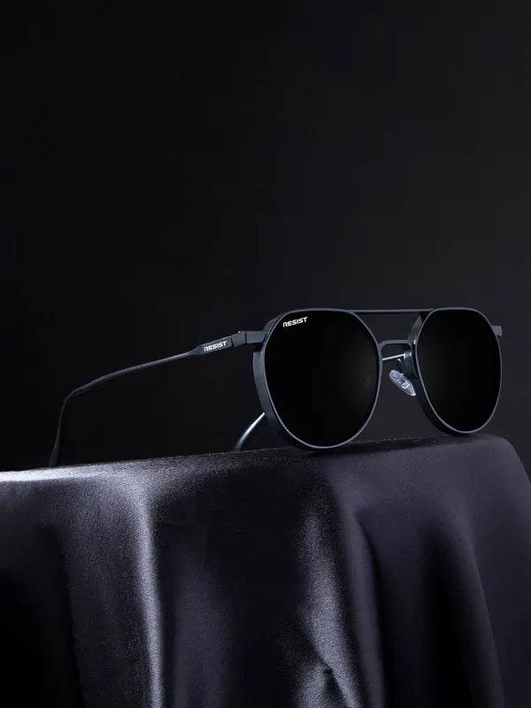 Sunglass Lover Stevan black oval glasses black metal oval sunglasses with thin temples on dark fabric