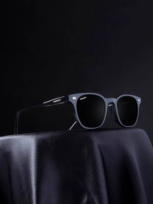 Sunglass Lover black square sunglasses with matte frame and dark lenses on draped cloth display UV protected square sunglasses