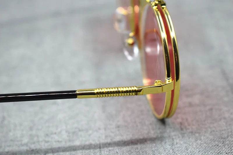 Sunglass Lover gold round frame flip up sunglasses with pink lenses and detailed hinge close up