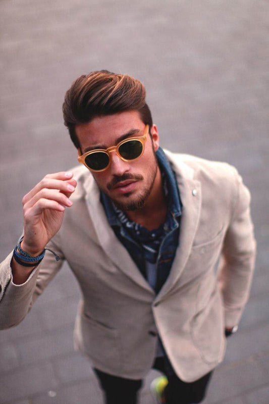 Sunglass Lover steampunk round sunglasses on stylish man in beige blazer adjusting gold frames