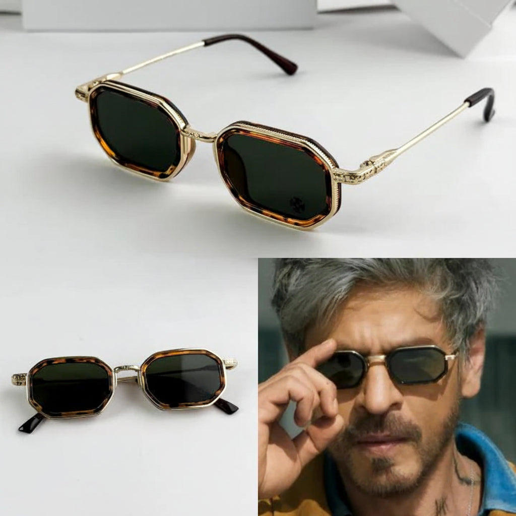 Sunglasses with gold frame and dark lenses, displayed on a white background.