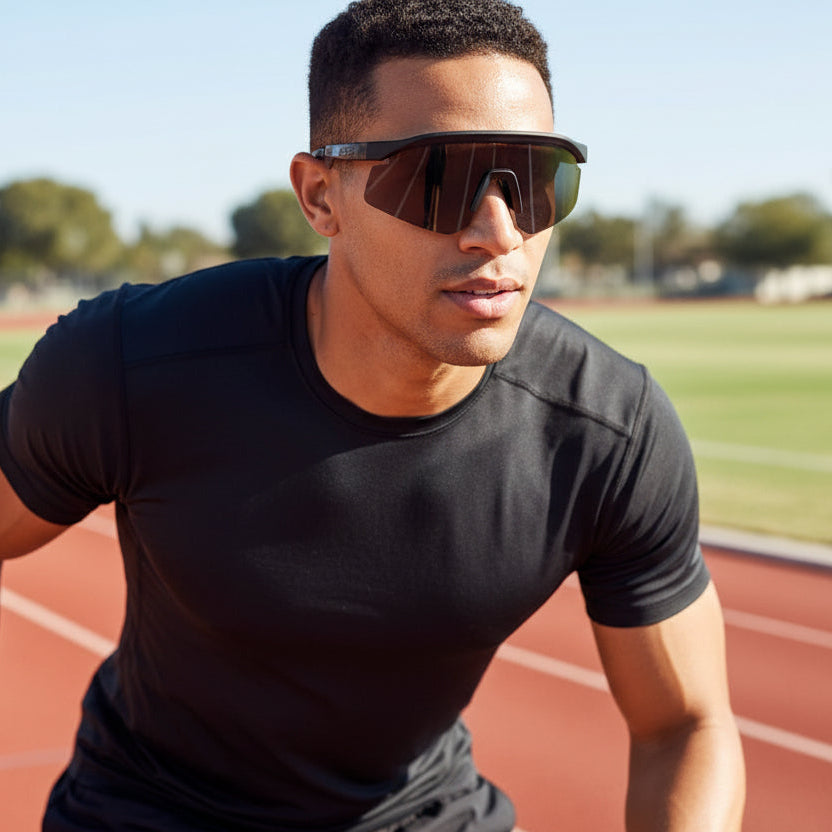 Man wearing sunglasses on a running track