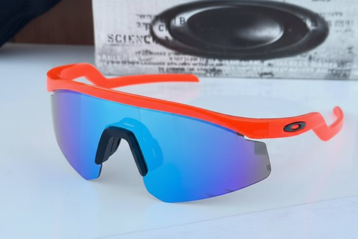 Sunglasses with red frame and blue mirror lens on a white surface