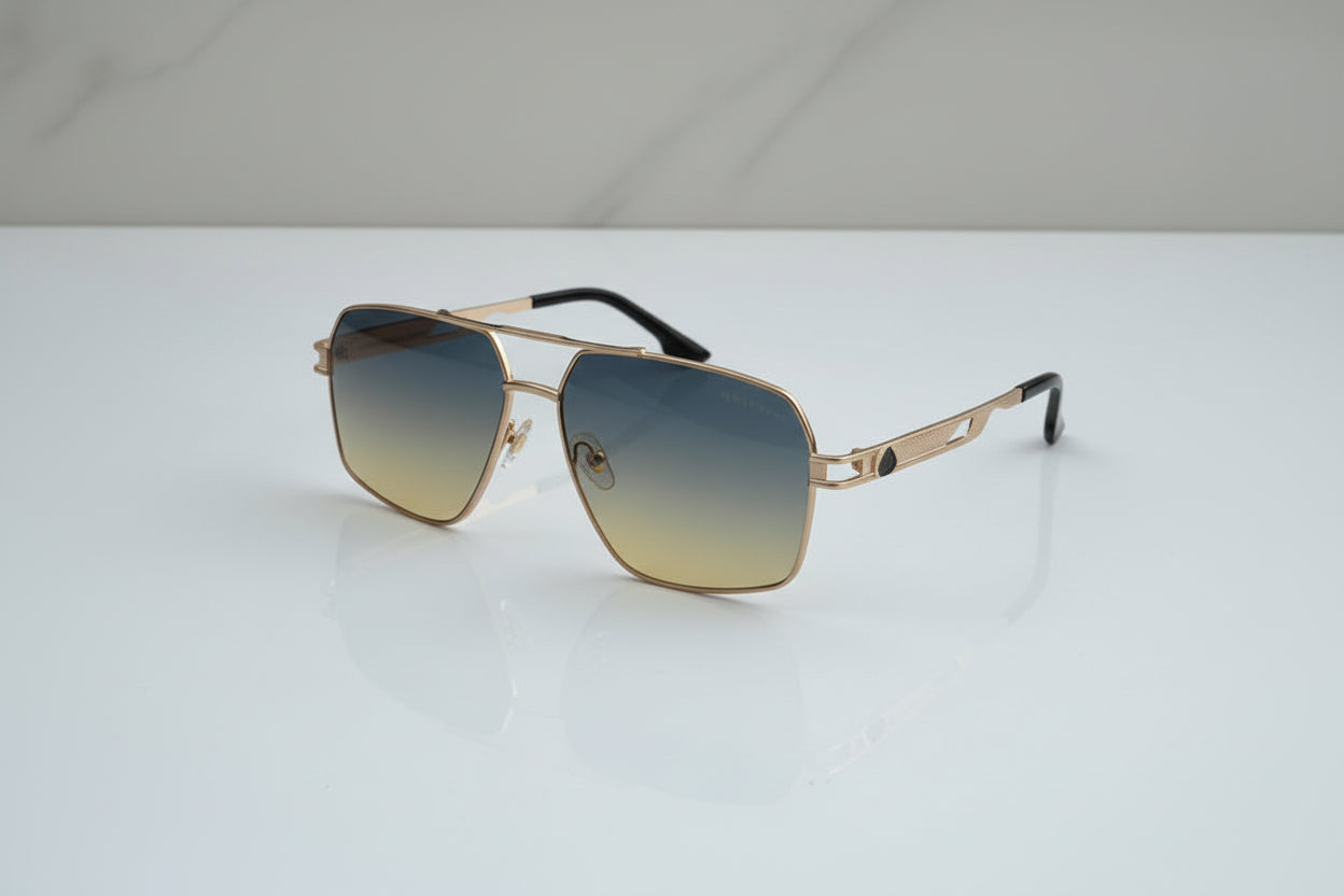 Gold-framed sunglasses with gradient lenses on a light gray background