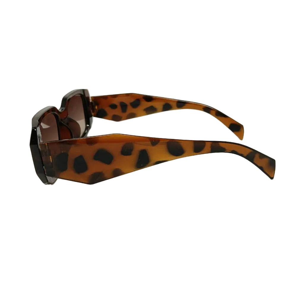 Sunglasses with leopard print frame on a light gray background