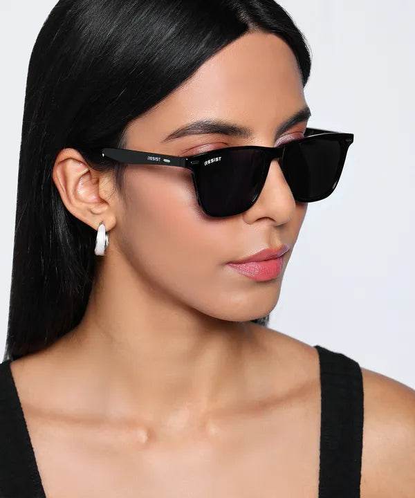 Sunglass Lover black UV protection oval square sunglasses worn by model with slim square frame and dark lenses