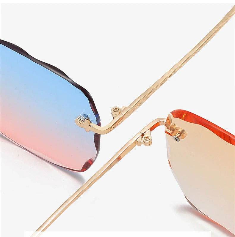 Sunglass Lover rimless oversize square sunglasses with gold temples and blue pink to amber gradient lenses close up