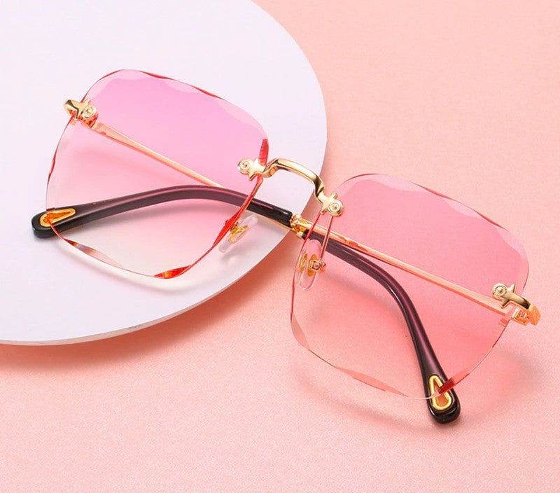 Sunglass Lover rimless oversize square sunglasses with pink gradient lenses gold bridge and black temple tips