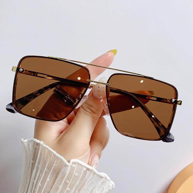 Sunglass Lover square rimless sunglasses for women brown lenses gold top bar tortoiseshell temples held in hand