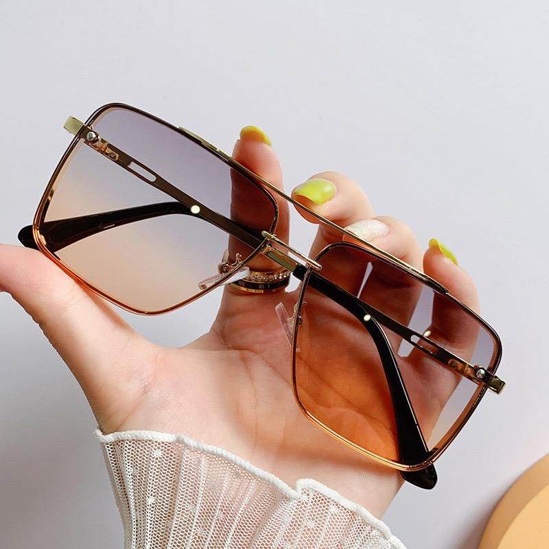 Sunglass Lover square rimless sunglasses for women brown gradient lenses gold accents held in hand
