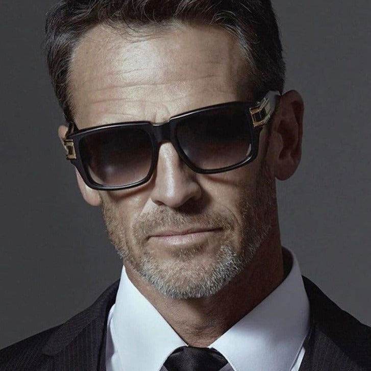 Sunglass Lover vintage thick square sunglasses worn by mature man in black frame with gold accents and suit