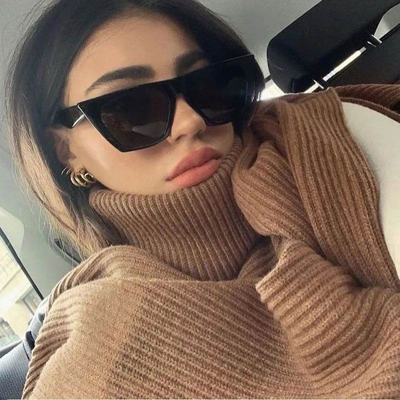 Sunglass Lover black cat eye sunglasses for women modeled by woman wearing brown turtleneck in car