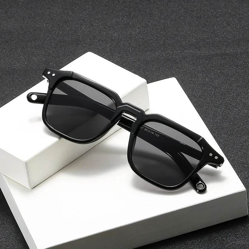 Sunglass Lover black vintage square sunglasses with glossy acetate frame and dark polarized lenses on white display blocks