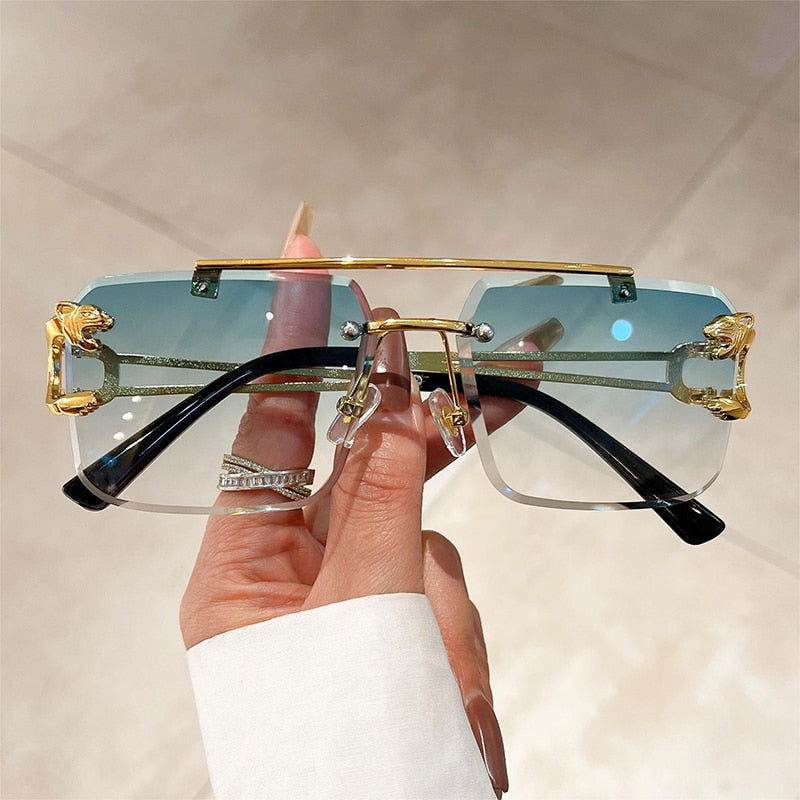 Sunglass Lover fashion rimless sunglasses trendy gold bar gradient blue lenses with black temples held by hand