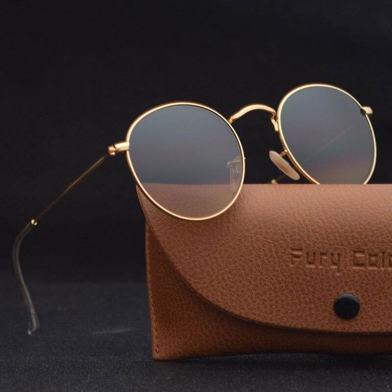 Sunglass Lover gold frame vintage round sunglasses for men and women. Resting on brown leather case