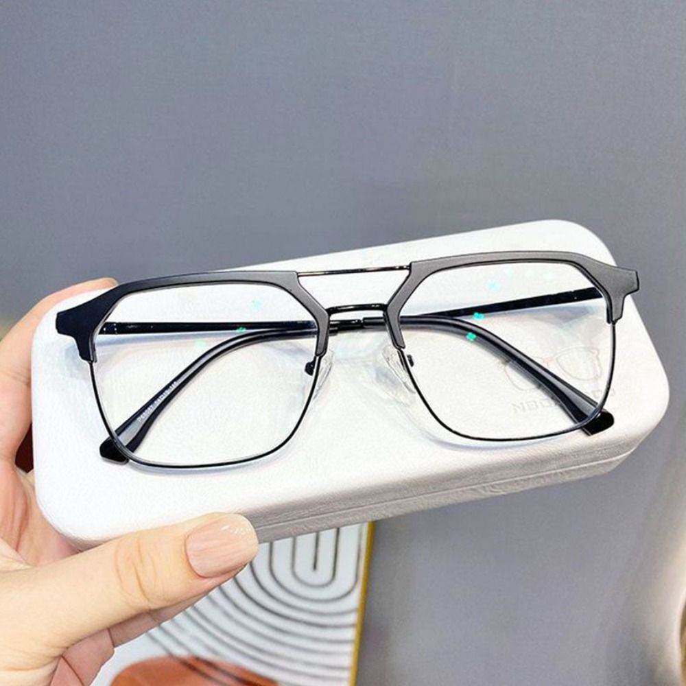 Black metal frame glasses with double bridge on white case held in hand anti-blue light glasses for men