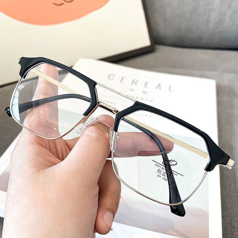 Hand holding black brow gold frame anti-blue light glasses for men clear lenses rectangular aviator style