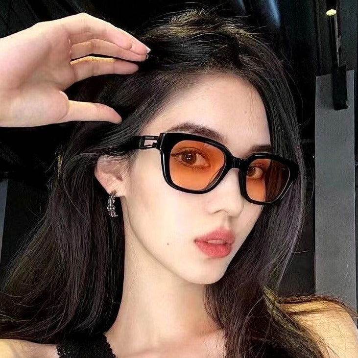 Sunglass Lover model wearing black frame sunglasses with orange lenses close up trendy rectangle sunglasses online India
