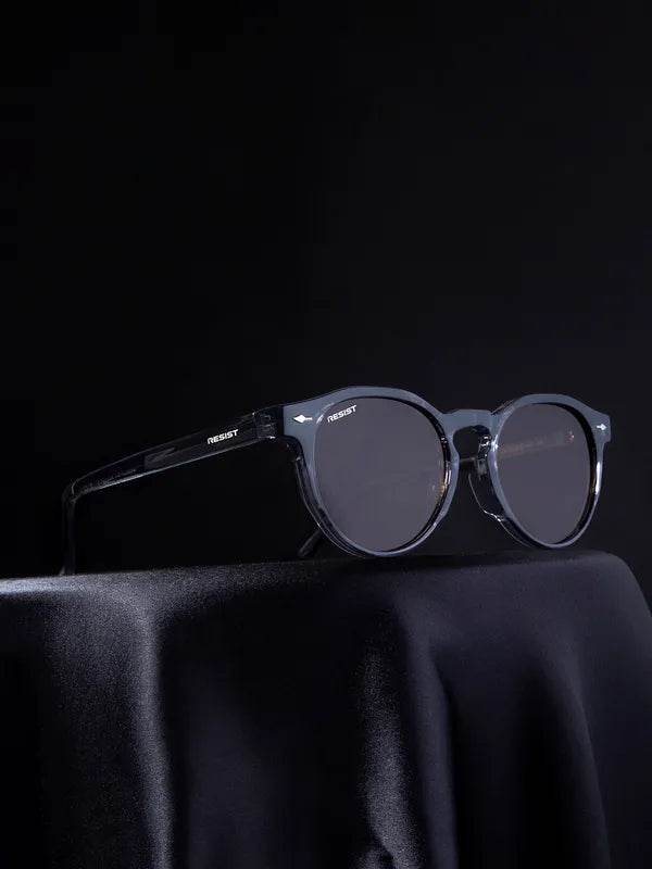 Sunglass Lover men's brown oval shades with translucent dark frame and smoke lenses on black drape