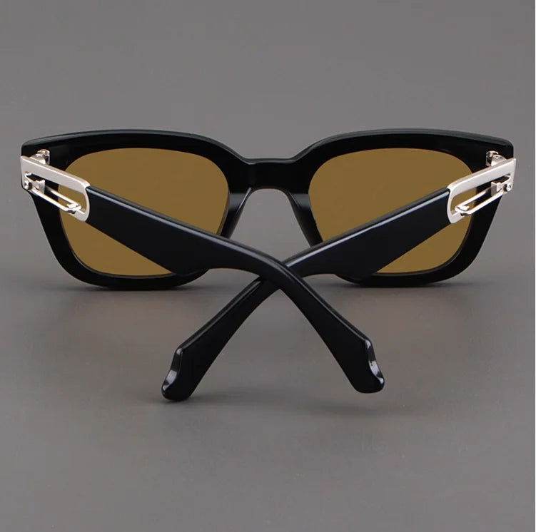 Sunglass Lover black sunglasses for men with brown lenses and gold hinge accents shown with crossed temples