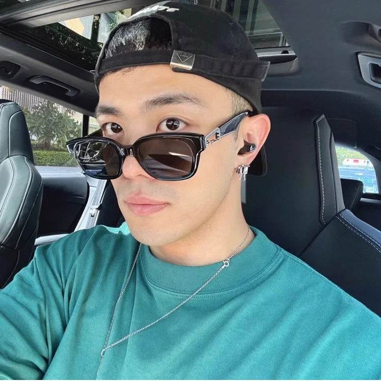 Man in car wearing Sunglass Lover black sunglasses for men with rectangular frames and silver temple accents