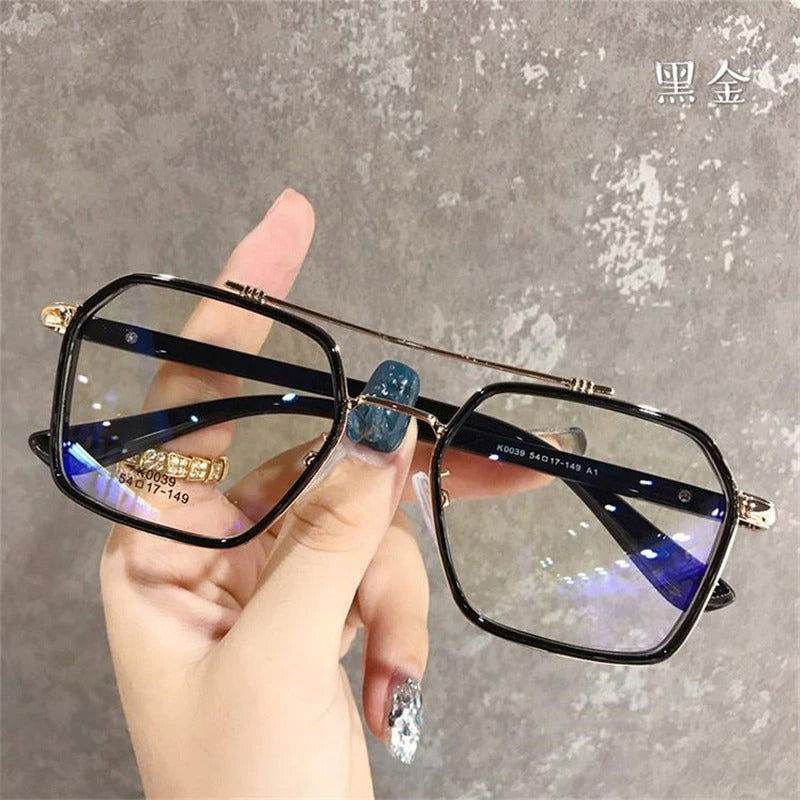 Sunglass Lover oversized anti-blue eyeglasses black gold square frames held in hand with blue lens reflection