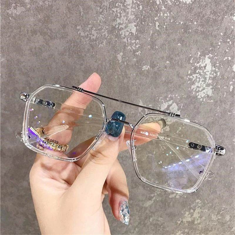 Sunglass Lover clear oversized anti-blue eyeglasses rectangular frames with silver brow bar held by hand