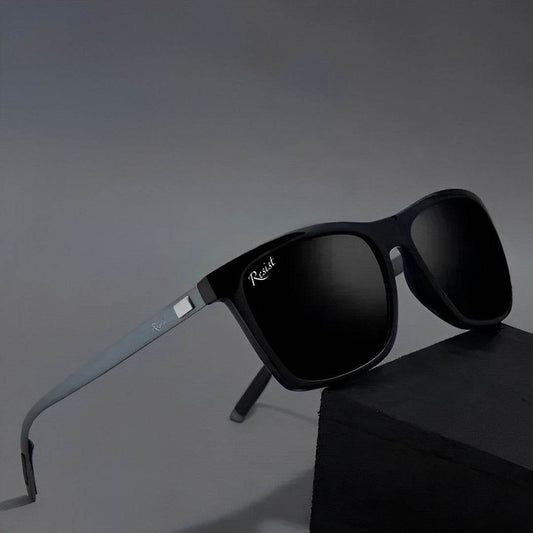 Sunglass Lover black wayfarer sunglasses with matte frame and dark polarized lenses on gray background