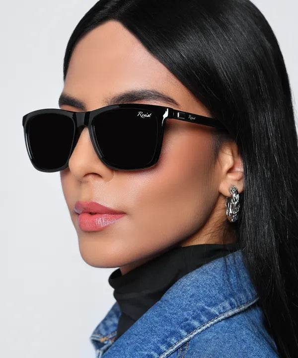 Sunglass Lover black wayfarer sunglasses on female model wearing denim jacket with glossy black frames and dark lenses