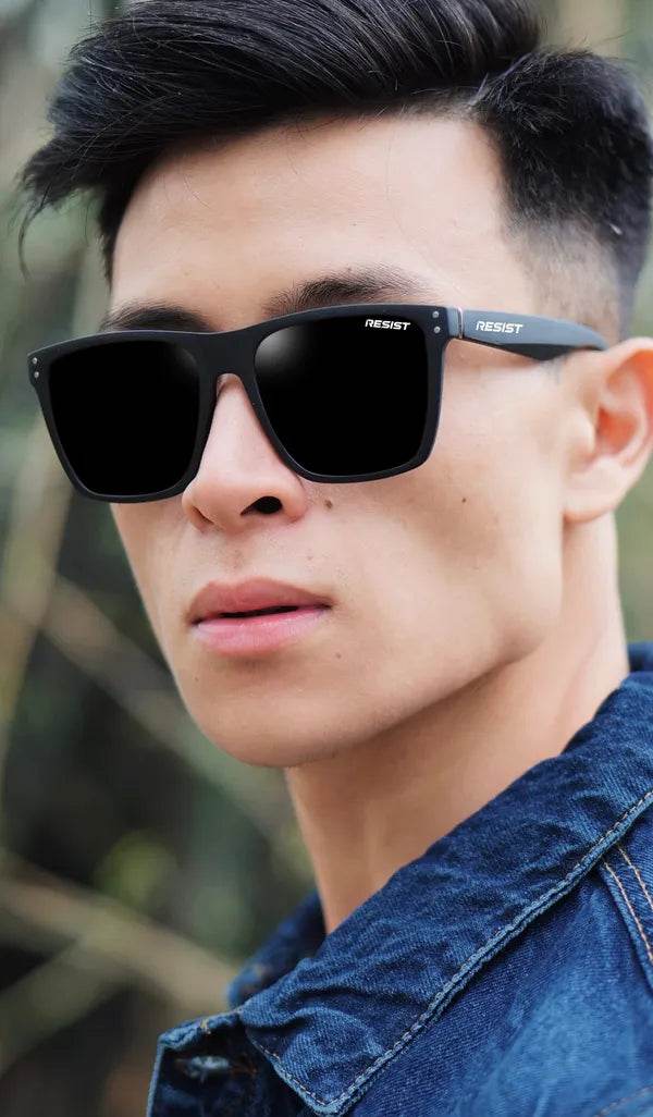 black wayfarer sunglasses for men by Sunglass Lover on male model wearing square black frames outdoors