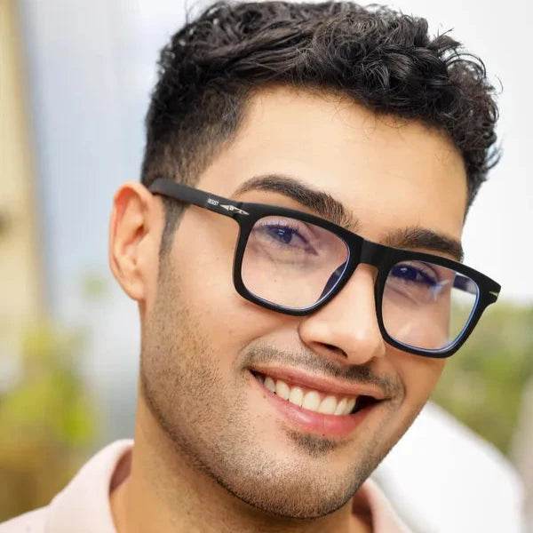 Smiling man wearing Sunglass Lover Antiblue black frame glasses showing blue light blocking eyeglasses for screen use