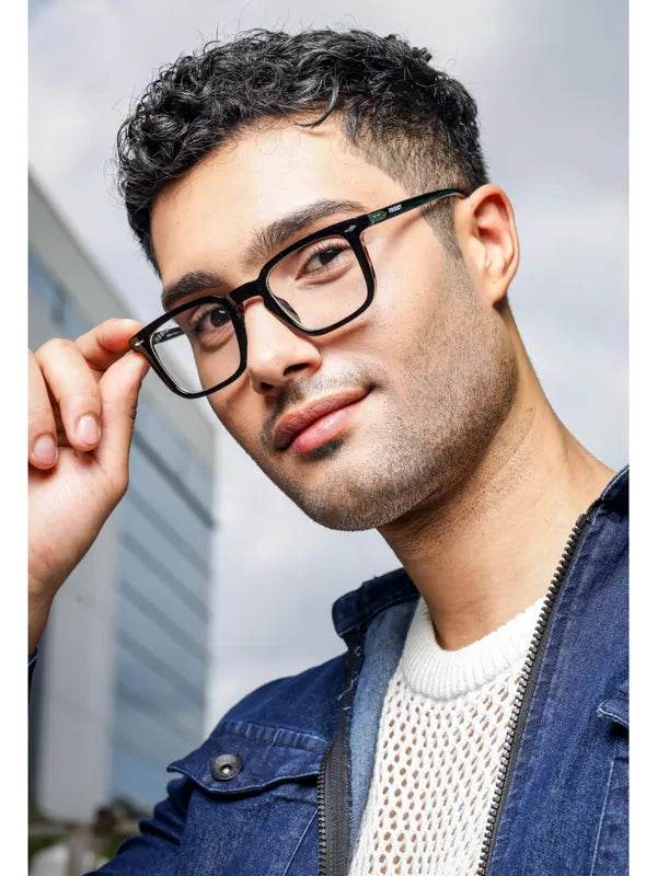 Young man wearing Antiblue eyeglasses from Sunglass Lover with clear black eyeglass frames in urban setting