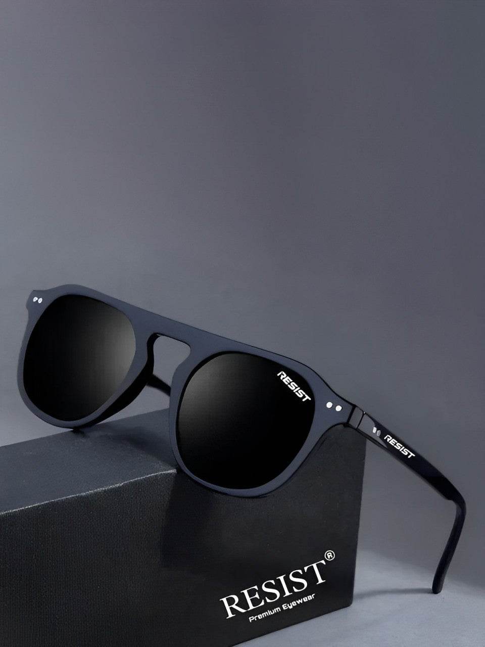 Sunglass Lover oval matte frame double bridge black sunglasses displayed on RESIST eyewear box