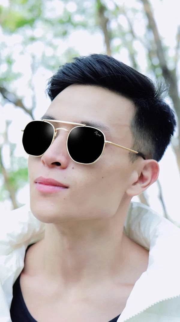 Octivia double bridge sunglasses hexagonal gold frame with black lenses on male model by Sunglass Lover