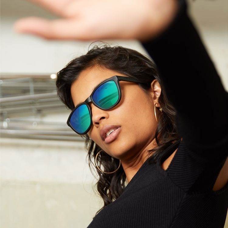 Model wearing Sunglass Lover polarized square wayfarer sunglasses with mirrored blue green lenses and black frame