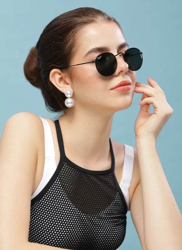 Sunglass Lover round black sunglasses on model with pearl earrings and black mesh top stylish look