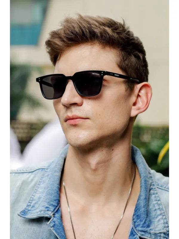 Male model wearing Sunglass Lover small black rectangle sunglasses with dark lenses and denim jacket