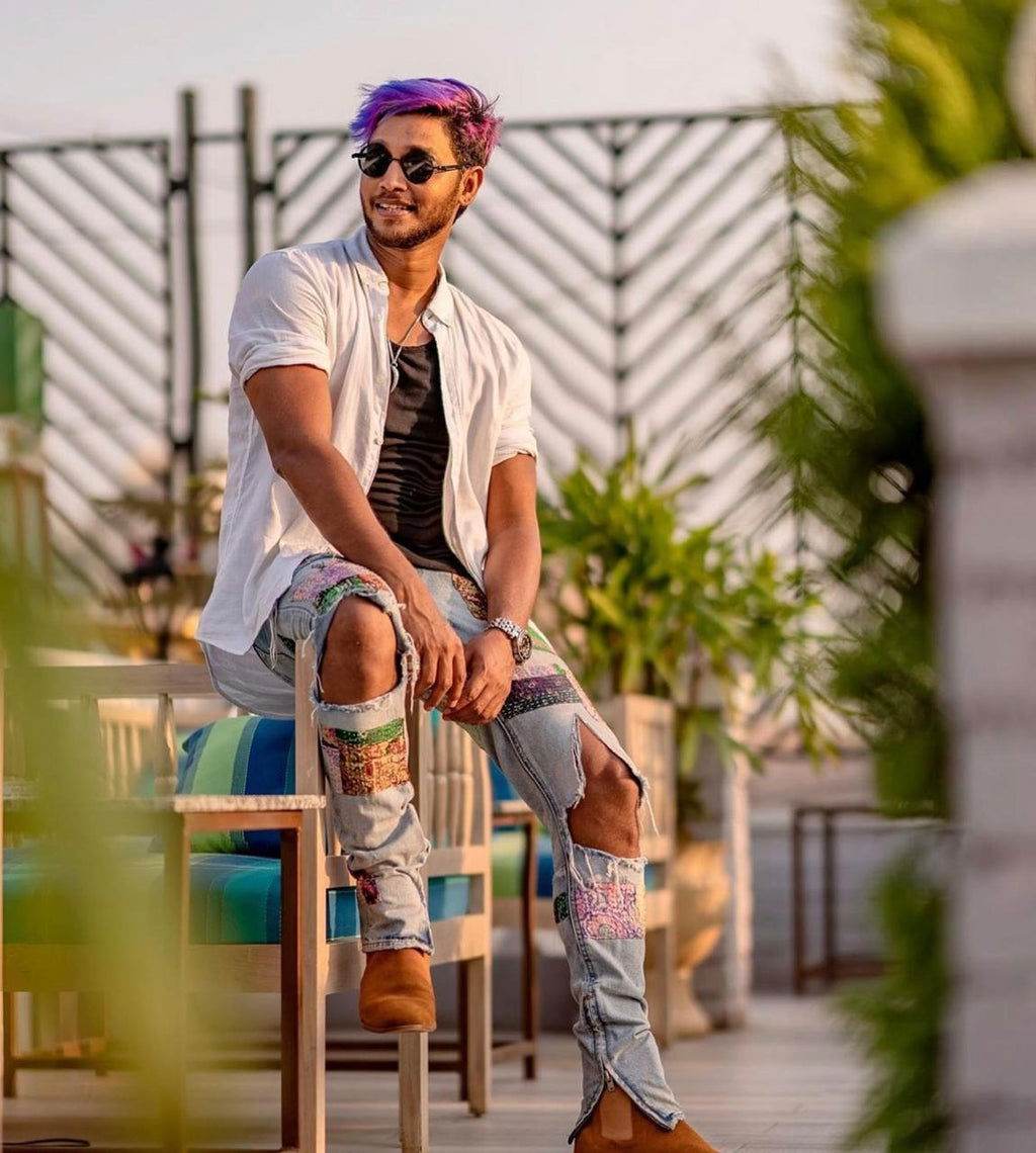 Sunglass Lover model wearing steampunk round sunglasses for men with white shirt and patchwork ripped jeans