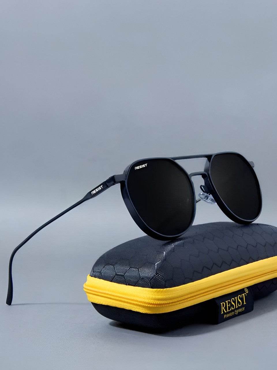 Sunglass Lover Stevan black oval glasses displayed on black textured protective case with yellow zipper