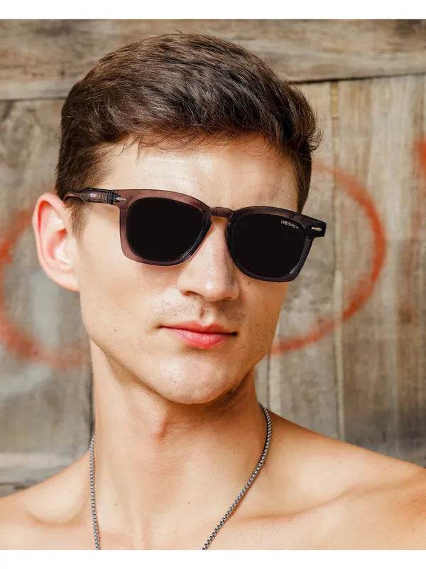 Sunglass Lover square sunglasses in storm grey black sunglasses worn by male model with dark lenses for casual street style