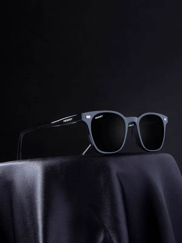 Sunglass Lover black square sunglasses with matte frame and dark lenses on draped cloth display UV protected square sunglasses