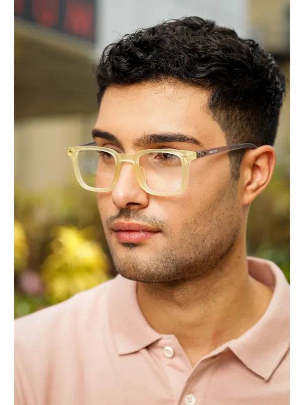 Sunglass Lover yellow clear eyeglass frames on male model with translucent rectangular lenses casual polo