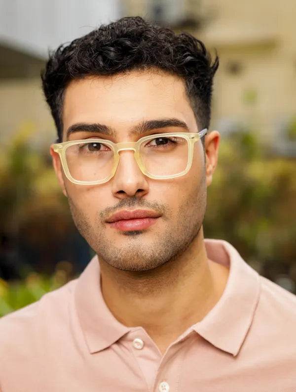 Sunglass Lover mens translucent square yellow clear eyeglass frames on a young man in a pink polo