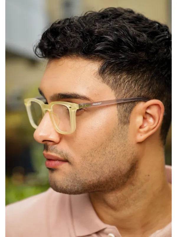 Sunglass Lover yellow clear eyeglass frames on male model with translucent square lenses and brown temples