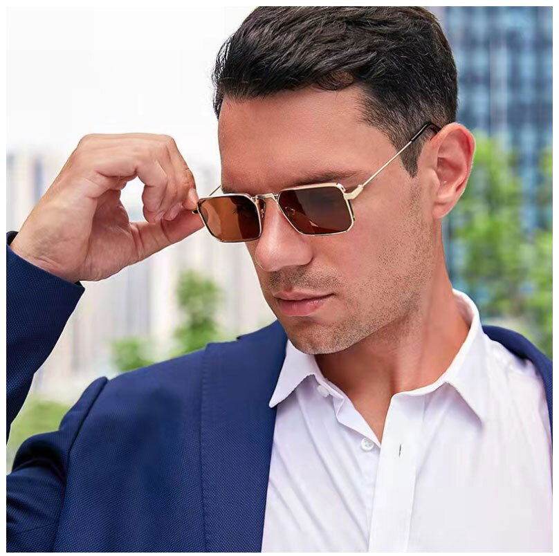 Sunglass Lover model in navy blazer wearing gold frame brown lenses and vintage rectangle sunglasses for men in city background