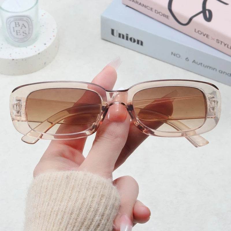 Sunglass Lover Jimmy Rectangle sunglasses translucent beige frame with gradient brown lenses held by hand