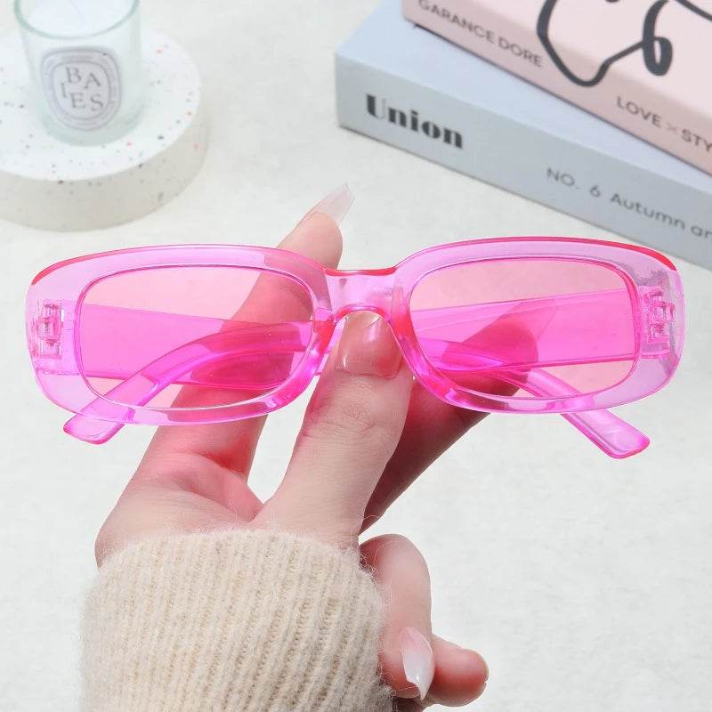 Sunglass Lover Jimmy Rectangle sunglasses translucent hot pink rectangular frames held in hand