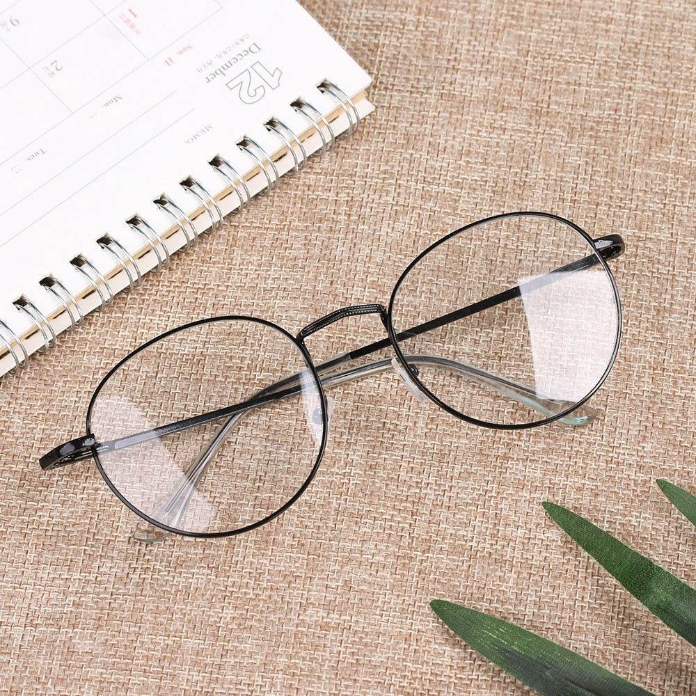 Sunglass Lover round metal frame reading glasses black thin wire rims clear lenses on burlap surface